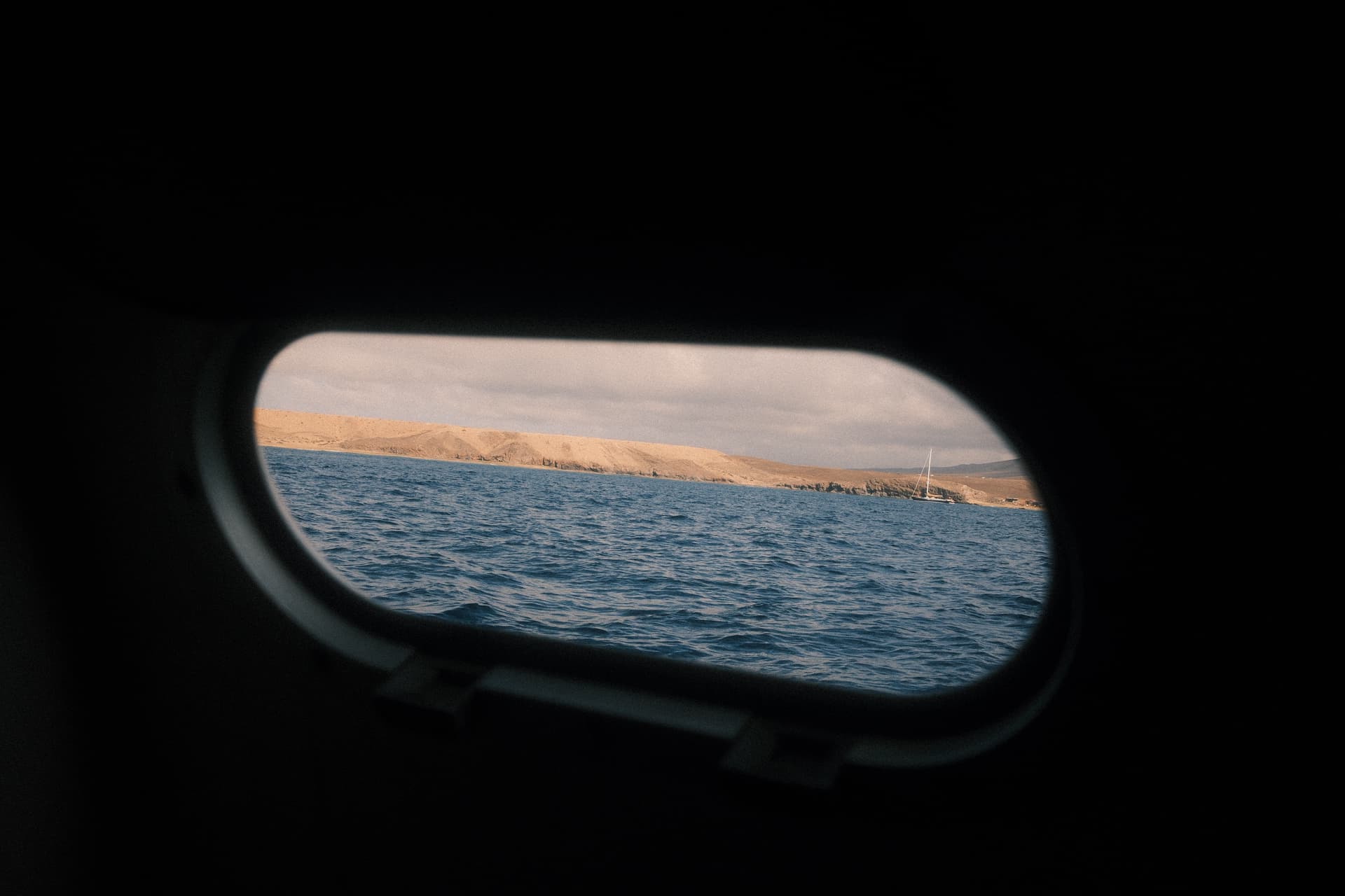 Lanzarote coastline through a porthole